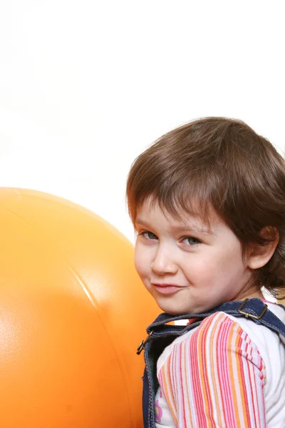 Dziewczynka gry z duża piłka pomarańczowy — Zdjęcie stockowe
