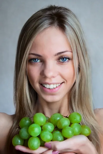 stock image The woman with grapes