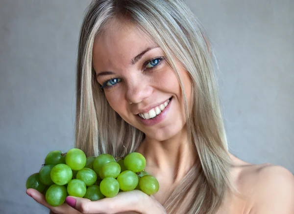 Stock image The woman with grapes