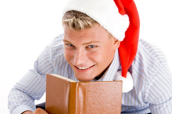 Pleased man with book and christmas hat — Stock Photo, Image