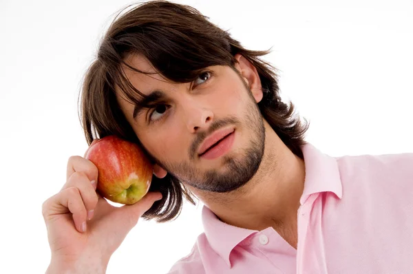 Hombre pensando y sosteniendo una manzana — Foto de Stock
