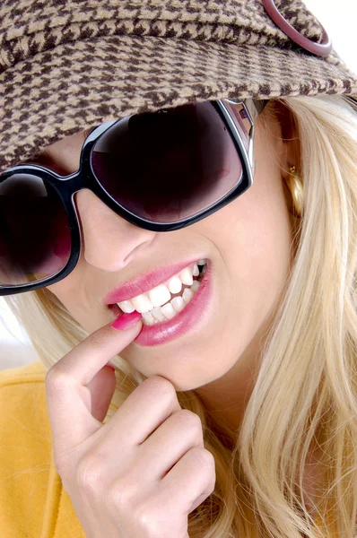 Smiling female biting her finger — Stock Photo, Image