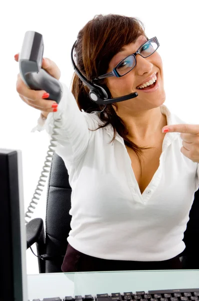 Female telecaller showing receiver — Stock Photo, Image
