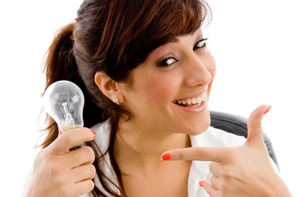 Young woman pointing at bulb — Stock Photo, Image