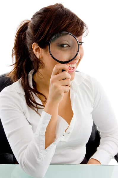 Female looking through lens and smiling — Stock Photo, Image