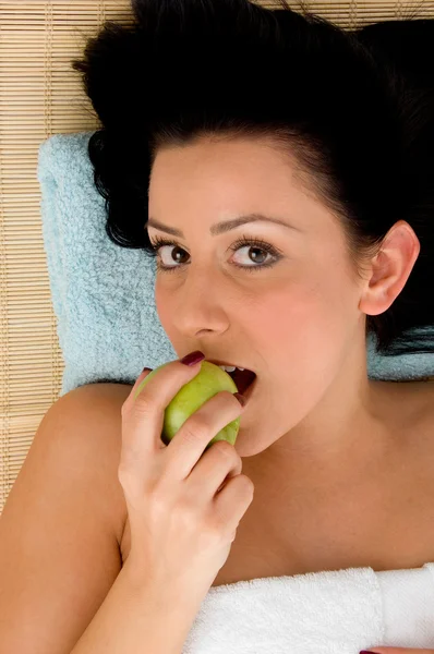 Jonge vrouw eet een appel — Stockfoto