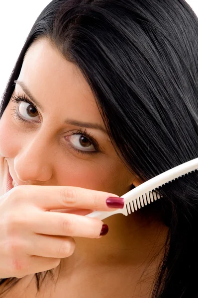 Adult woman combing her hair — Stock Photo, Image