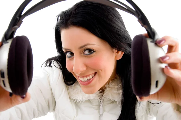 Femme souriante montrant des écouteurs — Photo