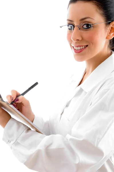 Läkare med att skriva pad och penna — Stockfoto