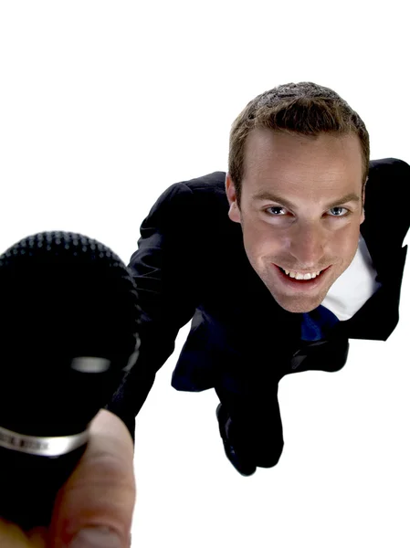 Podnikatel ukazující jeho mikrofon — Stock fotografie