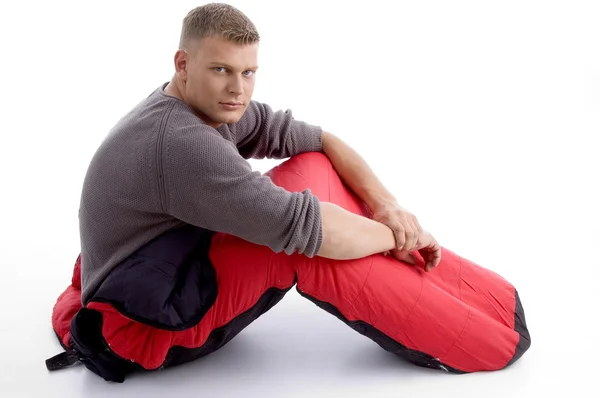 Guy posing in red sleeping bag — Stock Photo, Image