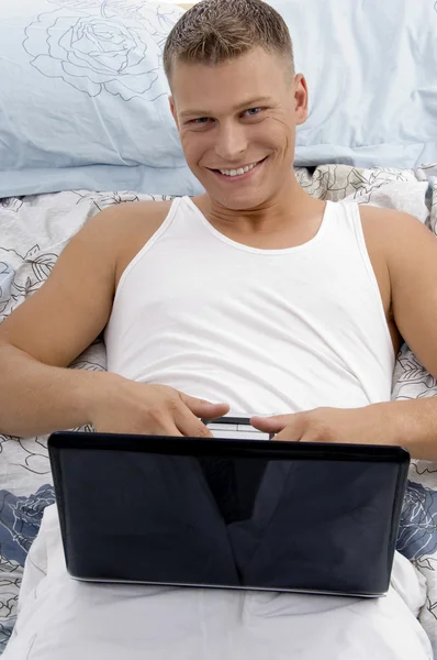 Young guy working on laptop — Stock Photo, Image