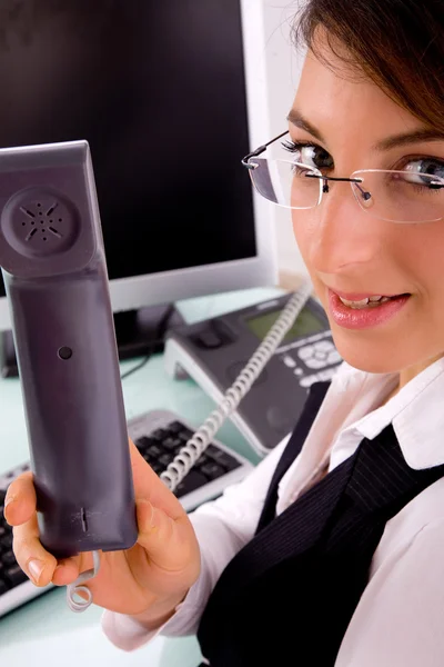 Businesswoman holding phone receiver — Stock Photo, Image