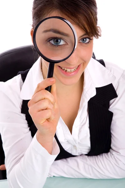 Smiling young woman holding magnifier — Stock Photo, Image