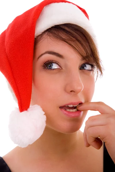 Frau mit Weihnachtsmütze denkt nach — Stockfoto