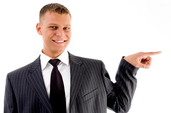 Pointing businessman looking at camera — Stock Photo, Image