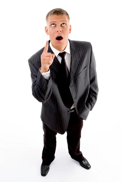 Shocked businessman pointing upwards — Stock Photo, Image