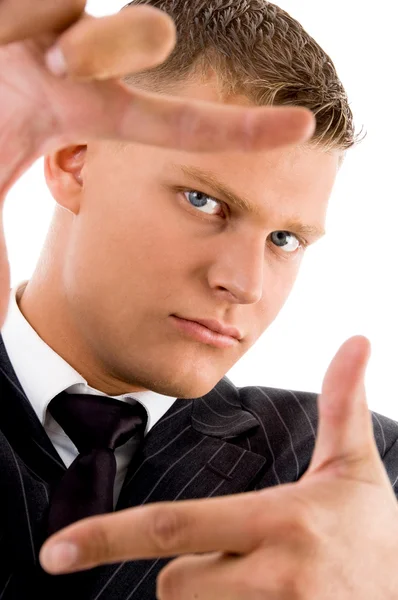 Uomo d'affari mostrando gesto cornice — Foto Stock
