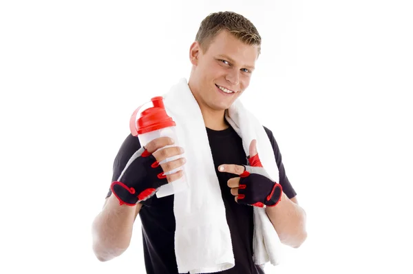 Smiling man pointing at water bottle — Stock Photo, Image