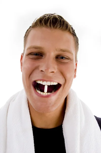 Homem segurando cápsula entre os dentes — Fotografia de Stock