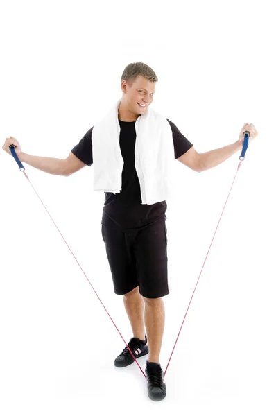 Muž protahovací cvičení lano — Stock fotografie