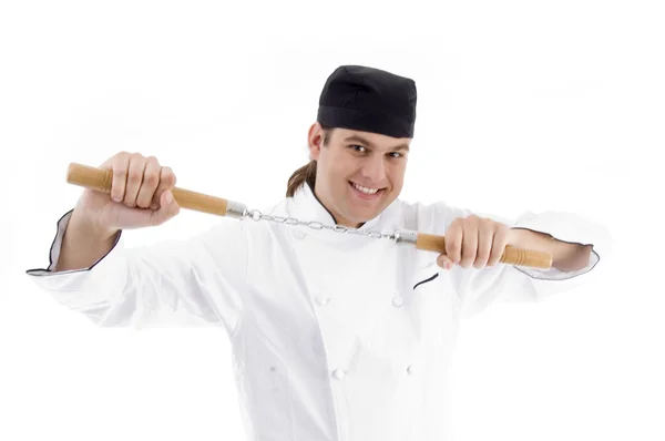 Mladý samec šéfkuchař hospodářství nunchaku — Stock fotografie