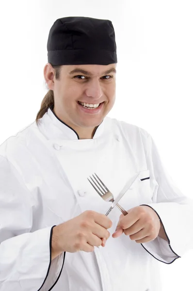 Mladý samec šéfkuchař drží vidličku a nůž — Stock fotografie