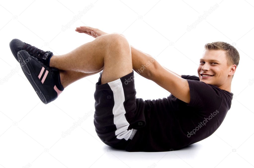 Handsome muscular guy doing crunches