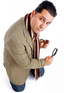 Detective with tobacco pipe and lens clipart