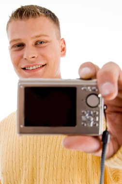 Handsome man showing digital camera