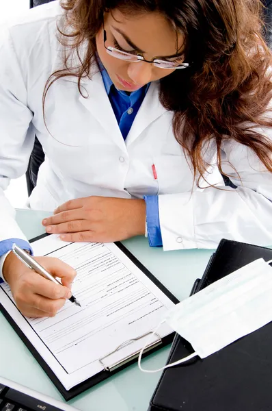 Young doctor writing prescription — Stock Photo, Image