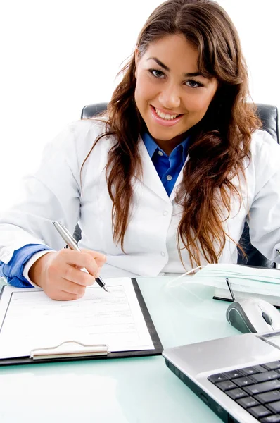 Smiling doctor writing prescription — Stock Photo, Image