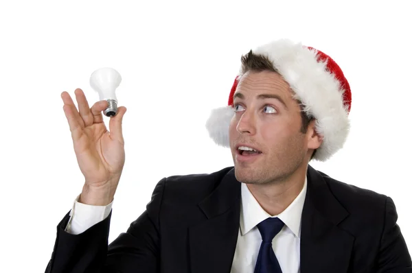 Businessman looking at bulb — Stock Photo, Image