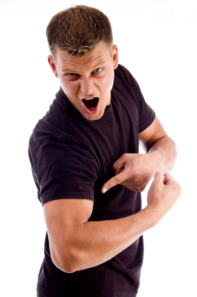 Shouting man pointing at his muscles — Stock Photo, Image