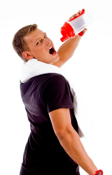 Muscular man drinking from water bottle — Stock Photo, Image