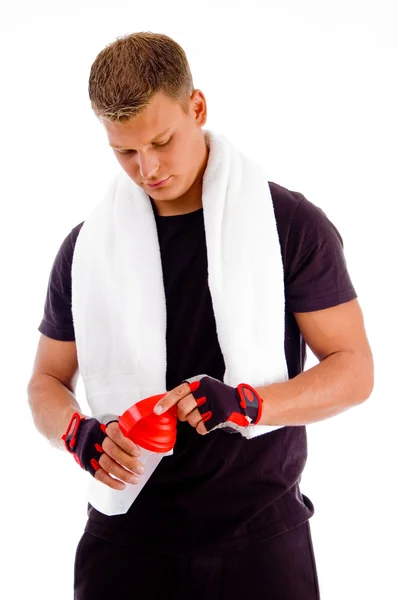 Muscular man opening bottle — Stock Photo, Image