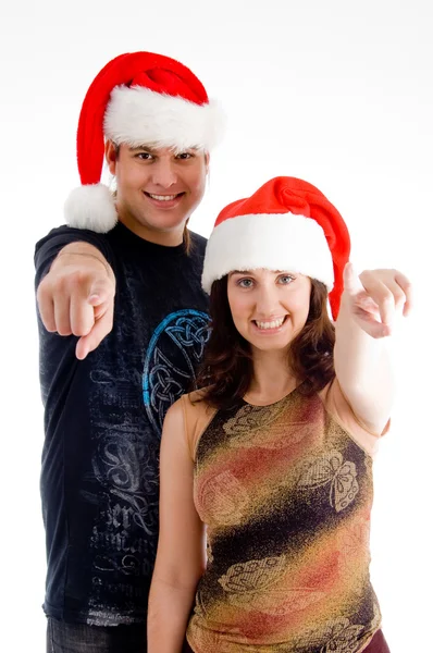 Vánoční pár ukazuje na kameru — Stock fotografie