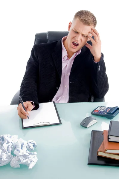 Upset businessman writing on pad — Stock Photo, Image