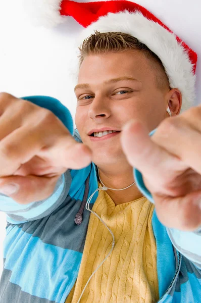 Указывая на улыбающегося мужчину в рождественской шляпе — стоковое фото