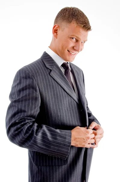 Young manager tucking his coat button — Stock Photo, Image