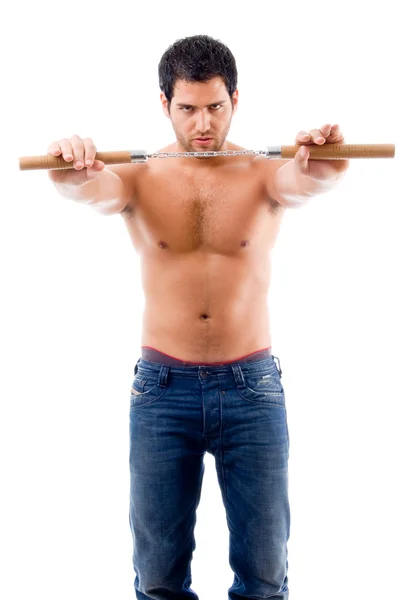 Strong man holding nunchaku — Stock Photo, Image