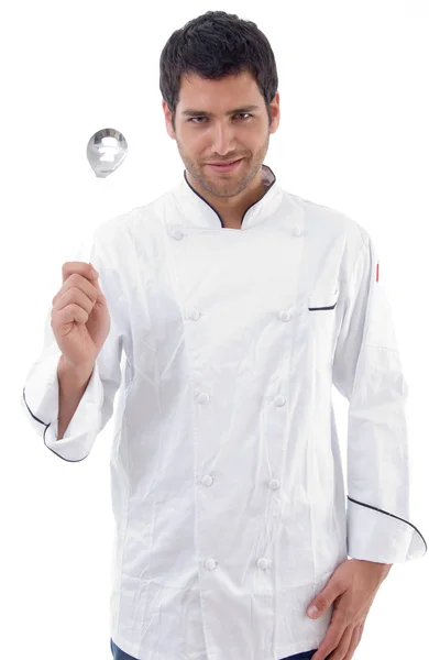 Young chef holding slotted spoon — Stock Photo, Image