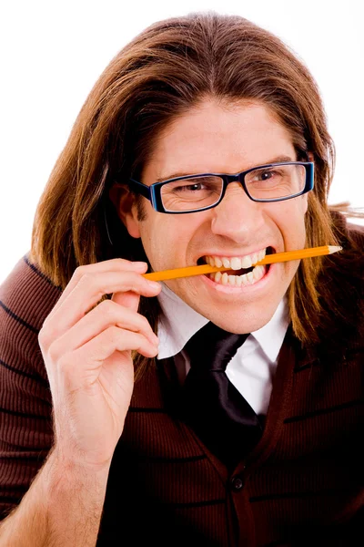Guy crushing pencil with his teeth — Stock Photo, Image