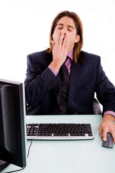 Tired young male executive yawning — Stock Photo, Image