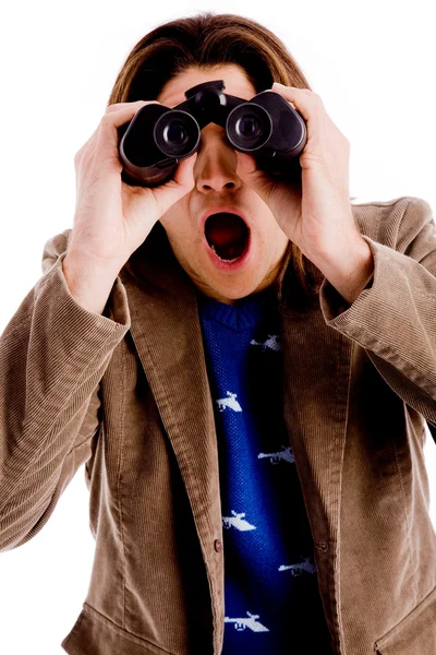 Shocked model looking through binoculars — Stock Photo, Image