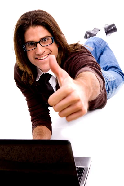 Smiling male with thumbs up on floor — Stock Photo, Image
