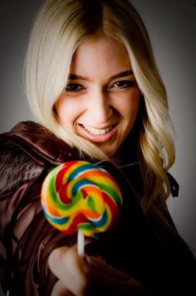 Smiling female offering candy — Stock Photo, Image