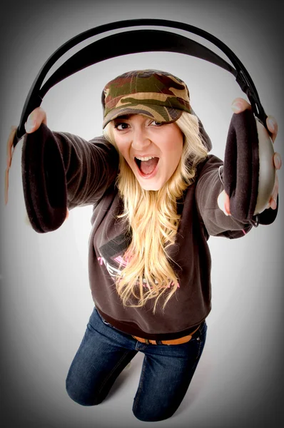 Shouting female holding headphones — Stock Photo, Image
