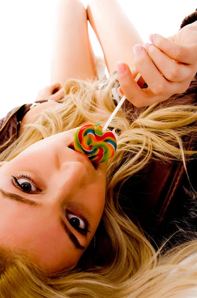 Sensuous woman licking candy — Stock Photo, Image