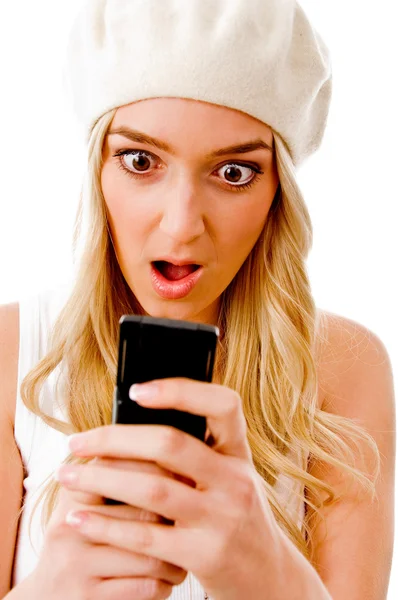 Surprised woman holding cellphone Stock Photo